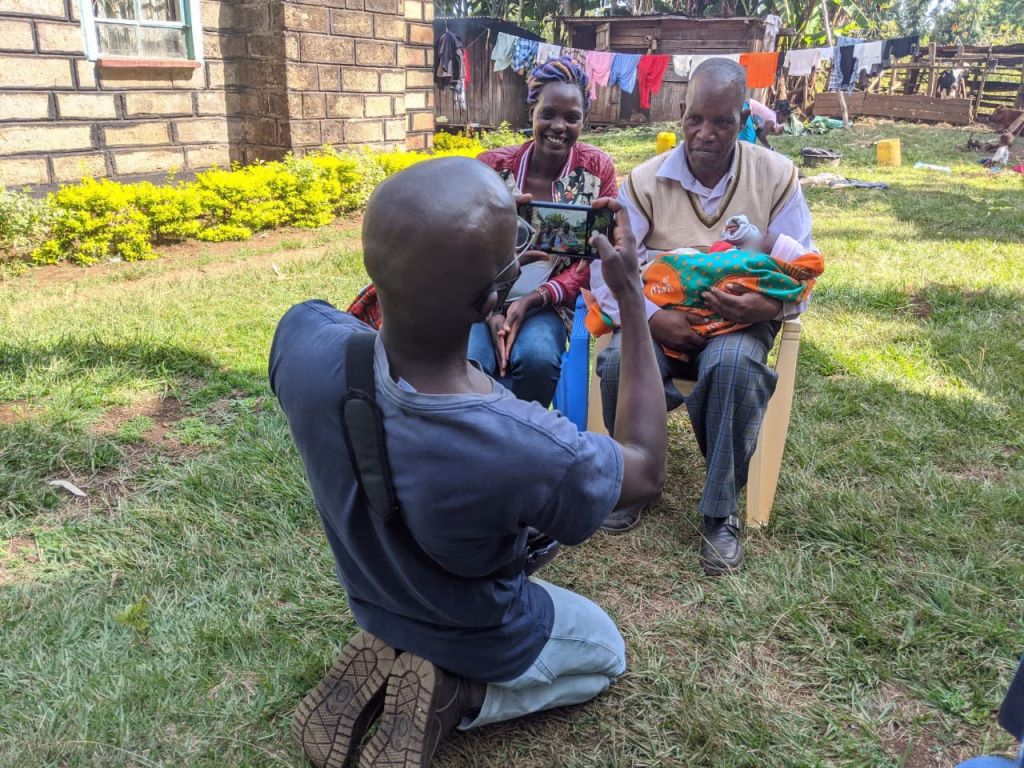 Richard holds his baby after attending #TeamDad groups in Meru.